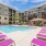 Resort inspired pool with hot tub and lounge chairs at Varela Westshore apartments